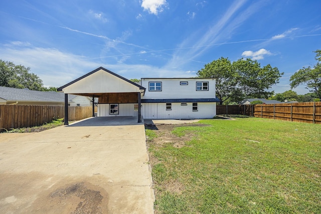 703 E Center St E, Duncanville, TX 75116 - back of property featuring a carport and driveway