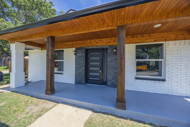 703 E Center St E, Duncanville, TX 75116 - property entrance featuring brick siding and a porch
