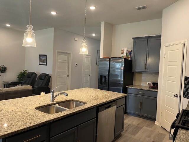 1311 Rosler St, Mansfield, TX 76063 - kitchen with a sink, stainless steel dishwasher, refrigerator with ice dispenser, light wood-style flooring, and tasteful backsplash