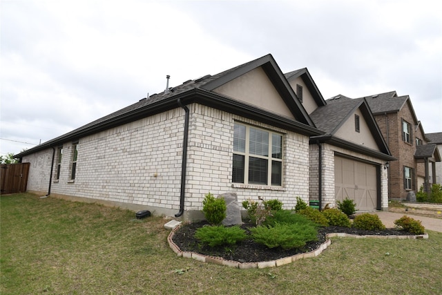 1311 Rosler St, Mansfield, TX 76063 - view of side of home featuring a garage, a lawn, driveway, and brick siding