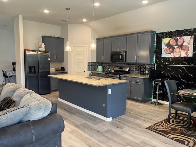 1311 Rosler St, Mansfield, TX 76063 - kitchen with appliances with stainless steel finishes, open floor plan, a sink, light stone countertops, and tasteful backsplash
