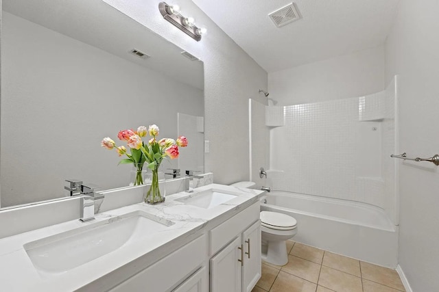 1409 Nicholas Ln, Little Elm, TX 75068 - full bathroom featuring toilet, double vanity, tile patterned floors, and washtub / shower combination