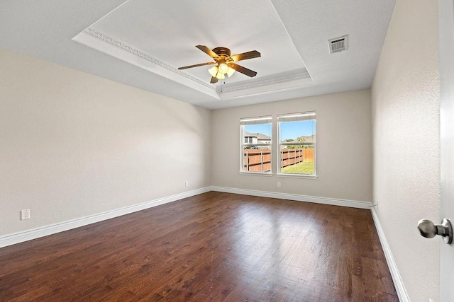 1409 Nicholas Ln, Little Elm, TX 75068 - spare room with a raised ceiling, ceiling fan, dark wood-style flooring, and baseboards