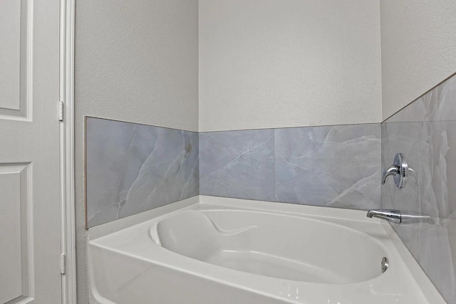1409 Nicholas Ln, Little Elm, TX 75068 - full bath featuring a bath and a textured wall