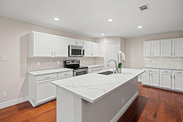 1409 Nicholas Ln, Little Elm, TX 75068 - kitchen featuring stainless steel appliances, a sink, backsplash, white cabinets, and dark wood-style flooring