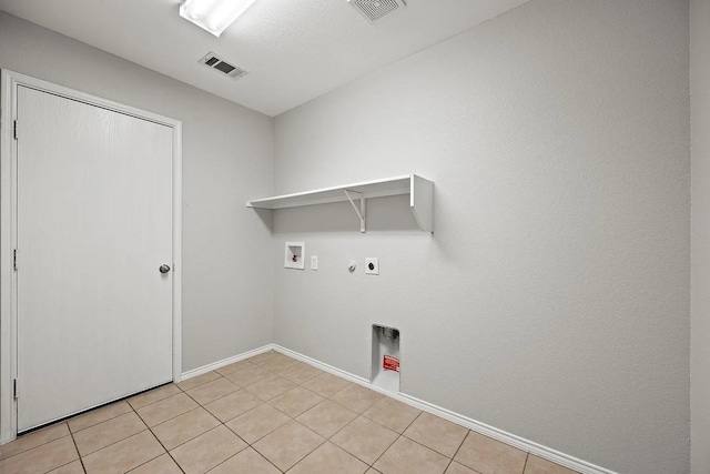 1409 Nicholas Ln, Little Elm, TX 75068 - laundry area with hookup for a gas dryer, hookup for an electric dryer, washer hookup, baseboards, and light tile patterned floors