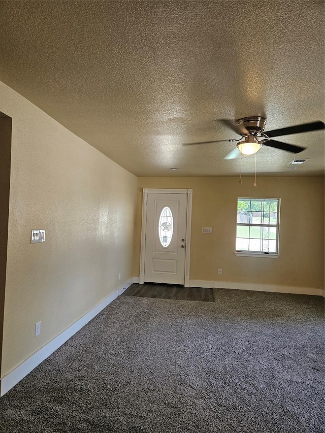5301 Bonnell Ave, Fort Worth, TX 76107 - foyer featuring dark carpet, baseboards, ceiling fan, and a textured ceiling