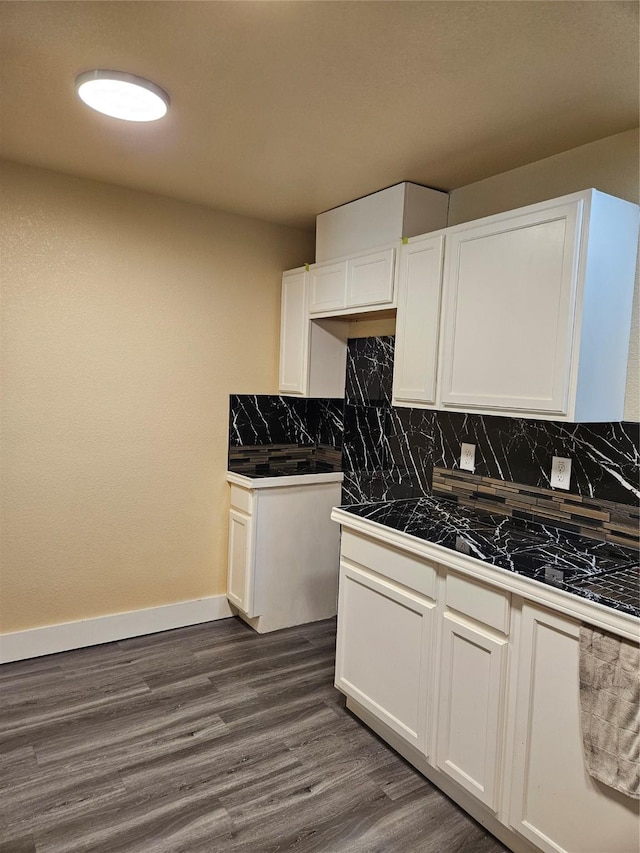 5301 Bonnell Ave, Fort Worth, TX 76107 - kitchen featuring decorative backsplash, white cabinetry, dark wood-style flooring, baseboards, and tile counters