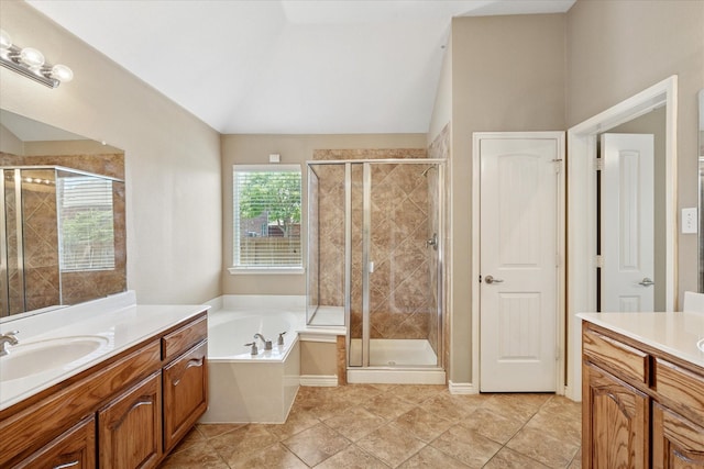 12712 Greenhaven Dr, Frisco, TX 75035 - bathroom with two vanities, vaulted ceiling, a stall shower, a garden tub, and tile patterned flooring