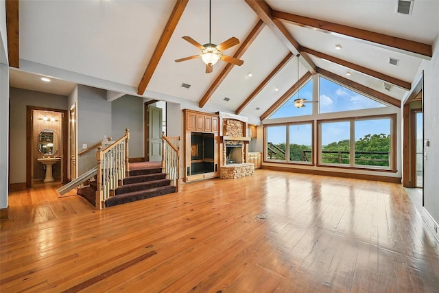 661 Diamond Point Dr, Oak Point, TX 75068 - unfurnished living room featuring ceiling fan, a fireplace, stairway, beamed ceiling, and high vaulted ceiling