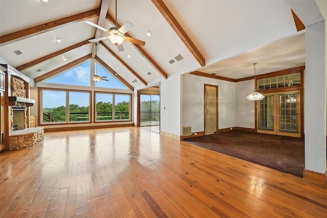 661 Diamond Point Dr, Oak Point, TX 75068 - unfurnished living room featuring ceiling fan, a stone fireplace, beam ceiling, hardwood / wood-style flooring, and high vaulted ceiling