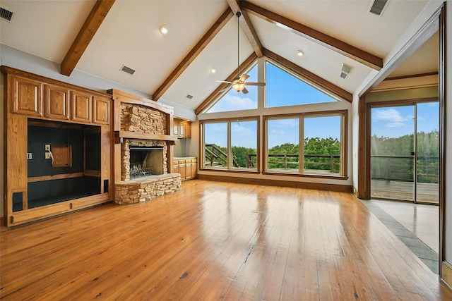 661 Diamond Point Dr, Oak Point, TX 75068 - unfurnished living room featuring a stone fireplace, beamed ceiling, ceiling fan, healthy amount of natural light, and light wood-type flooring