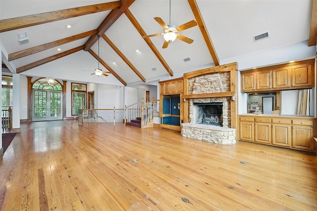 661 Diamond Point Dr, Oak Point, TX 75068 - unfurnished living room featuring a ceiling fan, beam ceiling, a fireplace, high vaulted ceiling, and light wood-style flooring