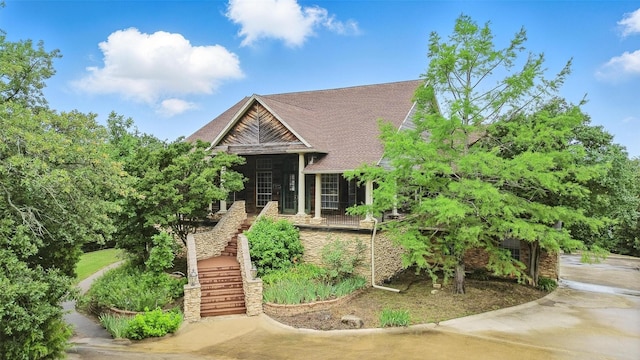 661 Diamond Point Dr, Oak Point, TX 75068 - view of front facade featuring stairs, stone siding, and roof with shingles