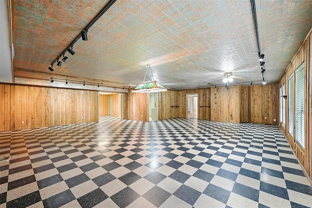 661 Diamond Point Dr, Oak Point, TX 75068 - below grade area featuring rail lighting, wood walls, and tile patterned floors