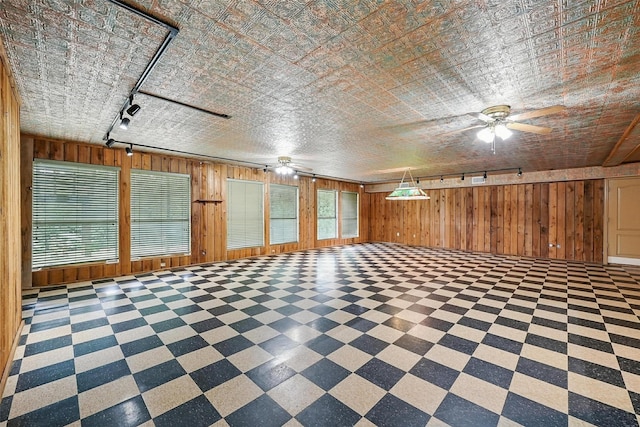 661 Diamond Point Dr, Oak Point, TX 75068 - empty room featuring wood walls, tile patterned floors, a ceiling fan, and track lighting