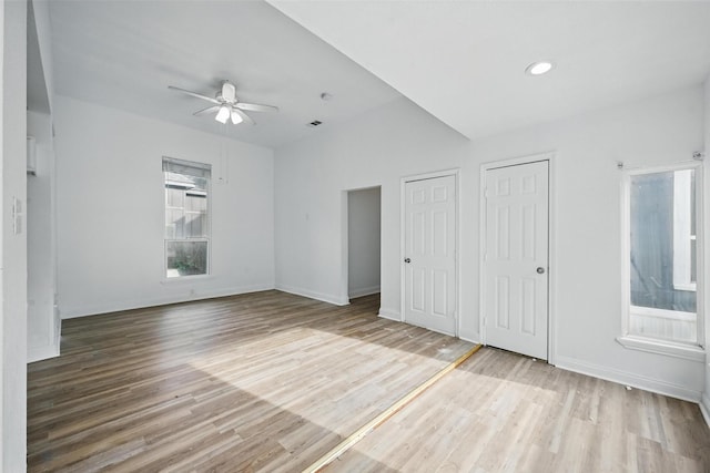 710 W Owing St, Denison, TX 75020 - unfurnished bedroom with wood finished floors, multiple closets, and recessed lighting