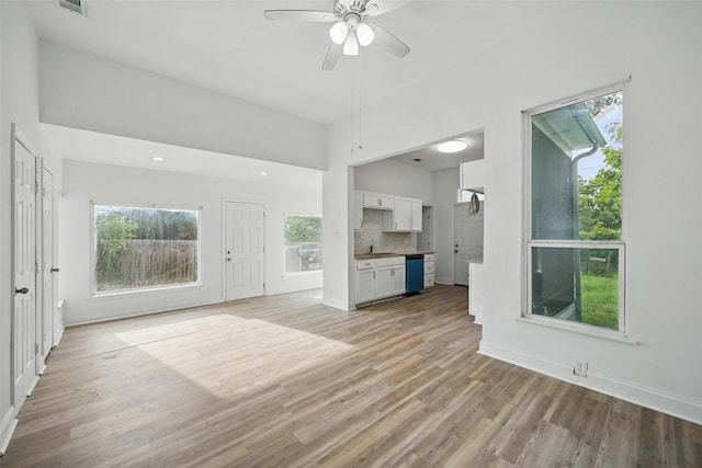 710 W Owing St, Denison, TX 75020 - unfurnished living room with plenty of natural light, light wood finished floors, and a ceiling fan
