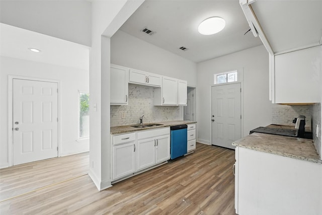 710 W Owing St, Denison, TX 75020 - kitchen with dishwasher, white cabinets, electric range, backsplash, and recessed lighting