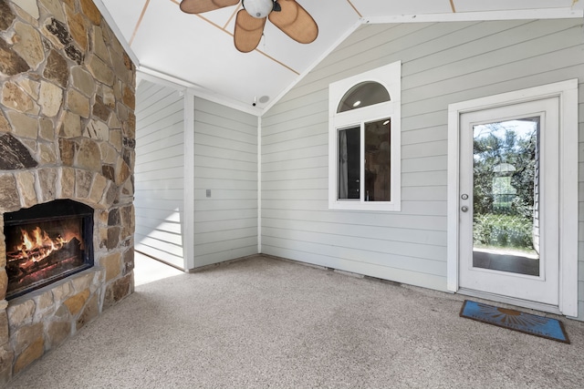 307 Sagebrush Dr, Oak Point, TX 75068 - unfurnished living room with lofted ceiling, carpet flooring, ceiling fan, a fireplace, and wood walls