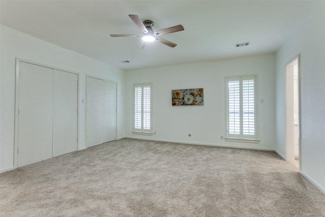 206 Crooked Creek Dr, Richardson, TX 75080 - unfurnished bedroom featuring two closets, carpet floors, and a ceiling fan