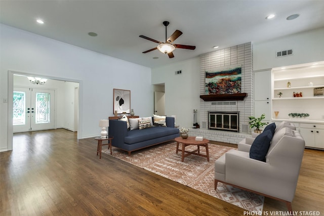 206 Crooked Creek Dr, Richardson, TX 75080 - living room featuring wood finished floors, ceiling fan, a brick fireplace, french doors, and recessed lighting