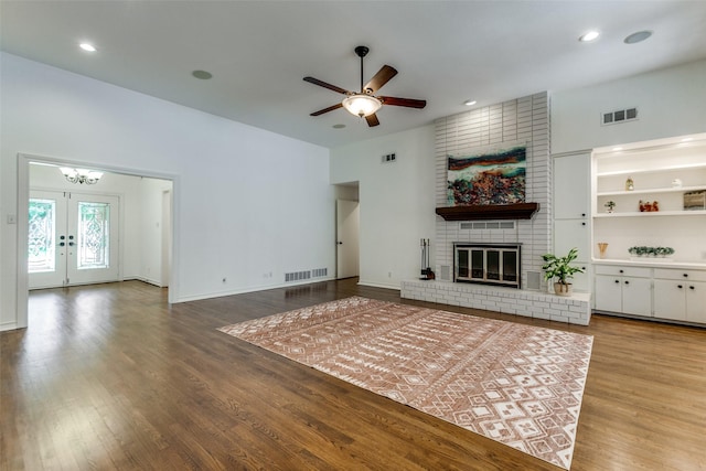206 Crooked Creek Dr, Richardson, TX 75080 - unfurnished living room featuring wood finished floors, a ceiling fan, a brick fireplace, french doors, and recessed lighting