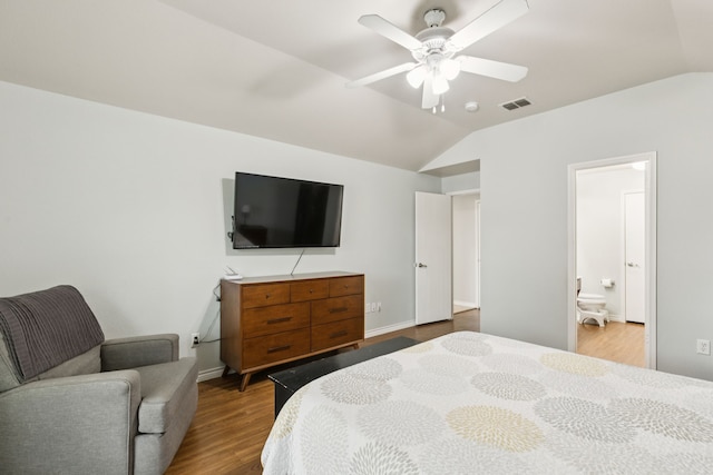 8824 Wagon Trl, Cross Roads, TX 76227 - bedroom with vaulted ceiling, wood finished floors, ensuite bath, and ceiling fan