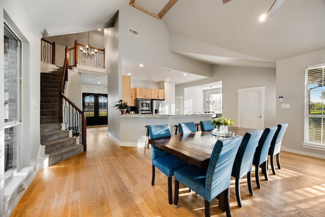 990 Cornelius Rd, Rockwall, TX 75087 - dining room with vaulted ceiling, stairs, a chandelier, light wood-style flooring, and baseboards