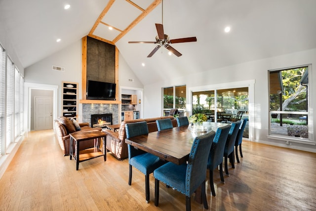 990 Cornelius Rd, Rockwall, TX 75087 - dining room featuring high vaulted ceiling, a glass covered fireplace, light wood-style flooring, a ceiling fan, and recessed lighting