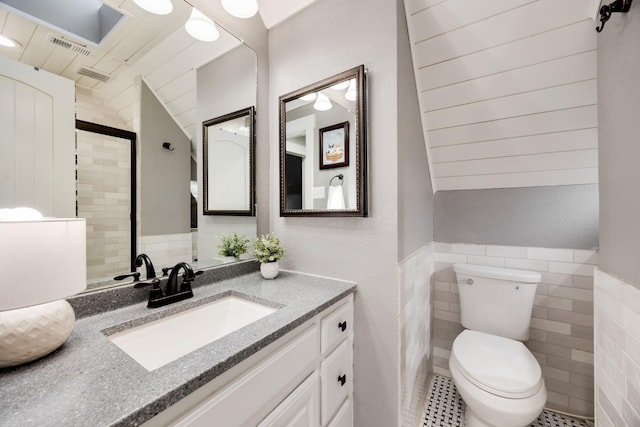990 Cornelius Rd, Rockwall, TX 75087 - full bath featuring tile walls, vanity, toilet, tile patterned flooring, and a shower