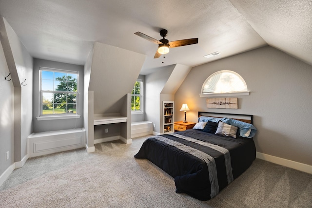990 Cornelius Rd, Rockwall, TX 75087 - carpeted bedroom with multiple windows, vaulted ceiling, baseboards, a ceiling fan, and a textured ceiling