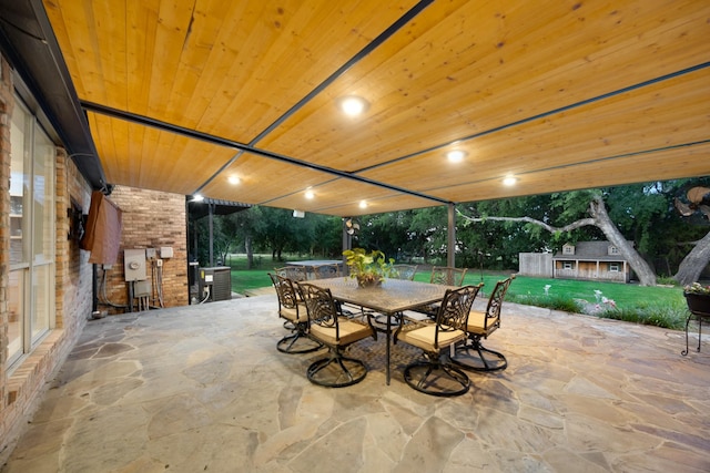 990 Cornelius Rd, Rockwall, TX 75087 - view of patio with outdoor dining space, central AC unit, and an outbuilding