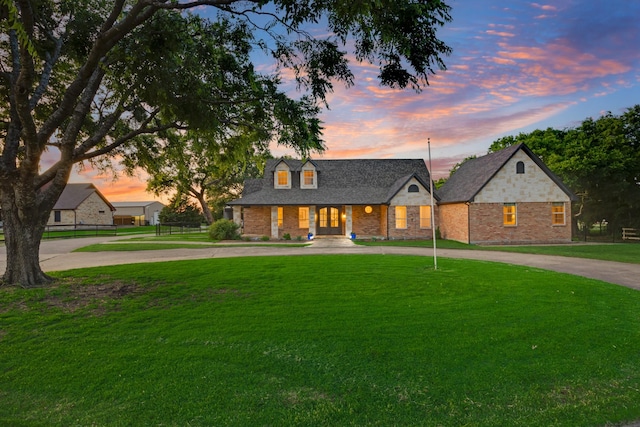 990 Cornelius Rd, Rockwall, TX 75087 - view of front of house with curved driveway, a yard, covered porch, and brick siding