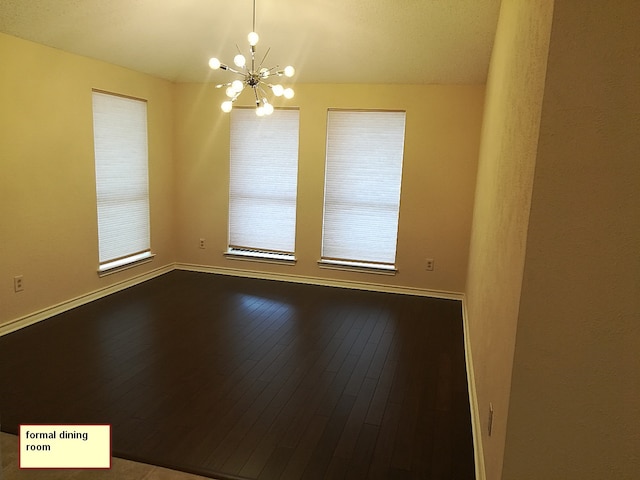 1211 Oriental Ave, Arlington, TX 76011 - empty room featuring a chandelier, hardwood / wood-style floors, baseboards, and plenty of natural light