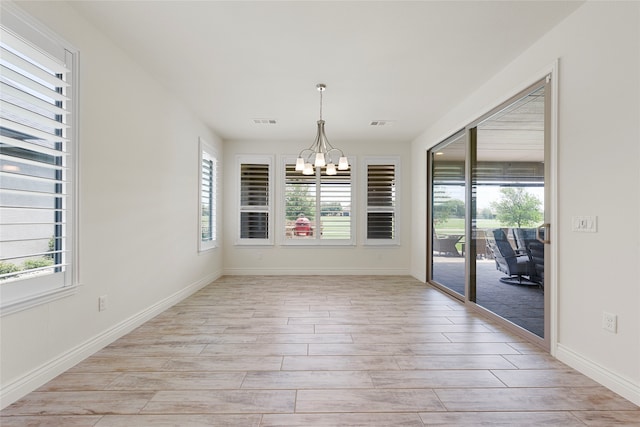 9921 Flint Way, Denton, TX 76207 - unfurnished dining area featuring a chandelier, light wood-style floors, and baseboards