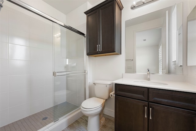 9921 Flint Way, Denton, TX 76207 - full bath featuring vanity, toilet, a shower stall, and wood finished floors
