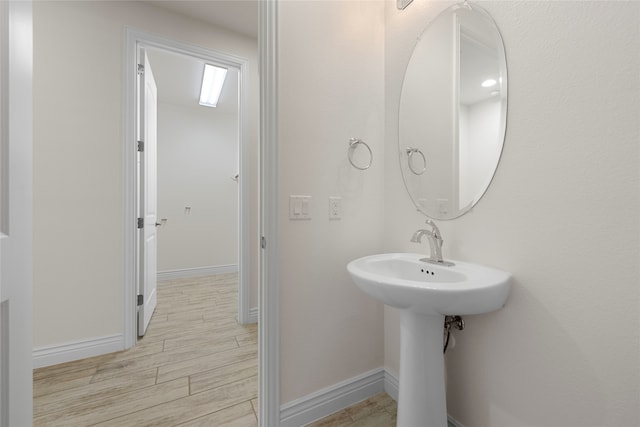 9921 Flint Way, Denton, TX 76207 - bathroom featuring wood finished floors and baseboards