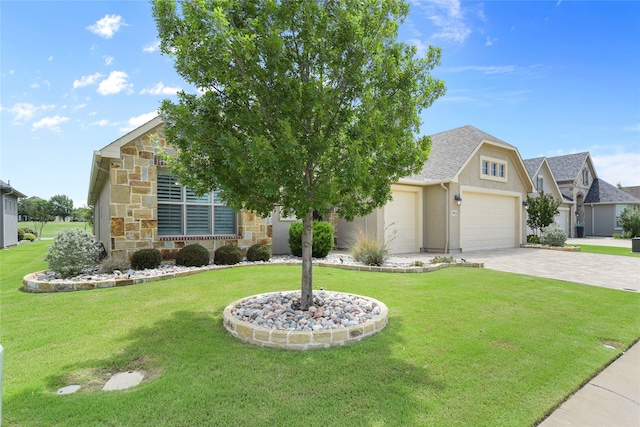 9921 Flint Way, Denton, TX 76207 - view of front of property featuring stone siding, decorative driveway, a front yard, and a garage
