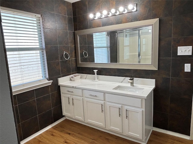 4026 Red Rock Dr, Heartland, TX 75126 - full bath with tile walls, vanity, wood finished floors, and plenty of natural light