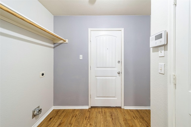 4026 Red Rock Dr, Heartland, TX 75126 - laundry area with wood finished floors, hookup for an electric dryer, and baseboards