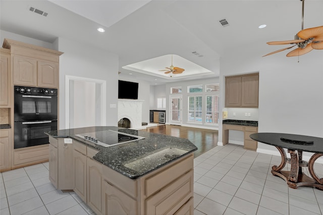 732 Richmond Ln, Keller, TX 76248 - kitchen with a ceiling fan, black appliances, a tray ceiling, light tile patterned flooring, and recessed lighting