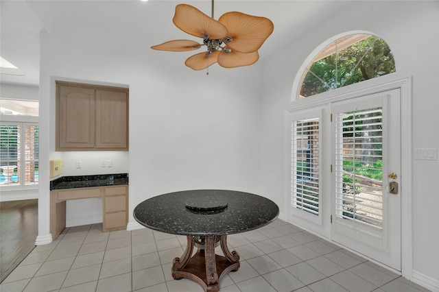 732 Richmond Ln, Keller, TX 76248 - unfurnished dining area with healthy amount of natural light, a high ceiling, baseboards, a ceiling fan, and light tile patterned floors