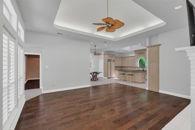 732 Richmond Ln, Keller, TX 76248 - unfurnished living room with a ceiling fan, a tray ceiling, light wood-style floors, and recessed lighting