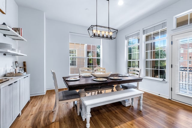 15763 Spectrum Dr Unit 93, Addison, TX 75001 - dining space with light wood-type flooring, a chandelier, and baseboards