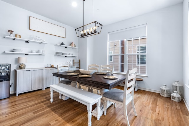 15763 Spectrum Dr Unit 93, Addison, TX 75001 - dining area with light wood-style floors, baseboards, and a chandelier