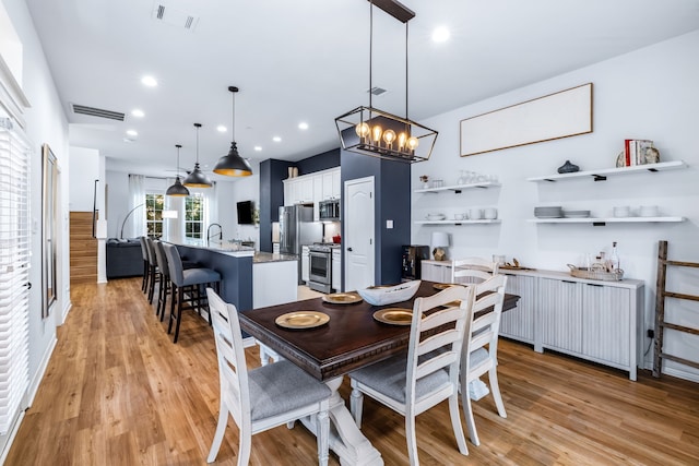 15763 Spectrum Dr Unit 93, Addison, TX 75001 - dining area with light wood-style floors, a chandelier, and recessed lighting