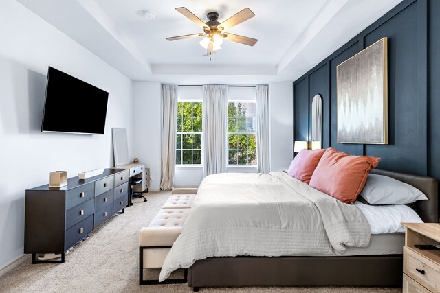 15763 Spectrum Dr Unit 93, Addison, TX 75001 - bedroom with light colored carpet, a raised ceiling, and a ceiling fan
