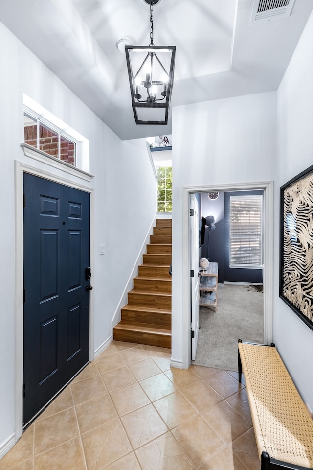 15763 Spectrum Dr Unit 93, Addison, TX 75001 - foyer featuring light tile patterned flooring, stairs, a chandelier, a tray ceiling, and baseboards