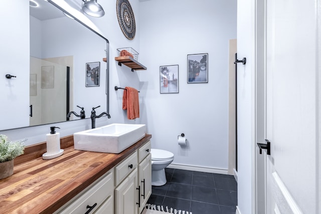 15763 Spectrum Dr Unit 93, Addison, TX 75001 - bathroom with vanity, toilet, tile patterned floors, baseboards, and a shower with shower door